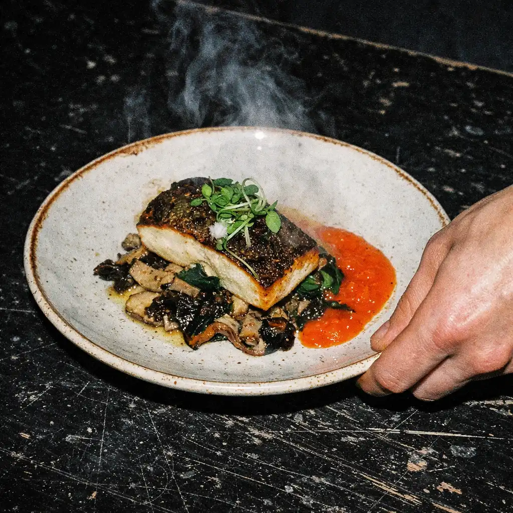 A finished plated dish on a scratched dark table